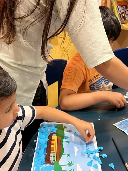 Look at the concentration on her face. During our Spring Camp, we created this beautiful landscape collage by tearing and pasting bits of colored paper, a fantastic exercise for strengthening little fingers.