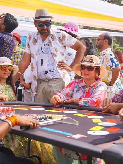 Guests enjoying the casino games at an outdoor event. The casual and fun atmosphere is perfect for a pre-wedding celebration like a Mehendi or welcome party.