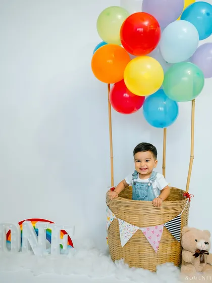 Let's celebrate big milestones with a touch of whimsy. This hot air balloon theme for a first birthday shoot adds a pop of color and imagination, creating a magical memory for your little one's special day.