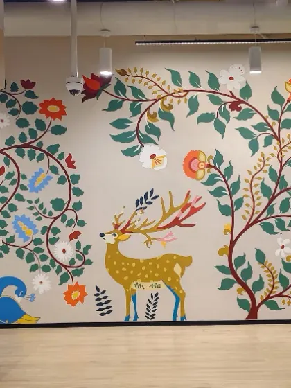 For the Databricks India office, we blended technology with tradition. This mural uses classic Indian art forms like Madhubani and Kalamkari to tell a modern story, featuring elephants and peacocks alongside corporate branding.