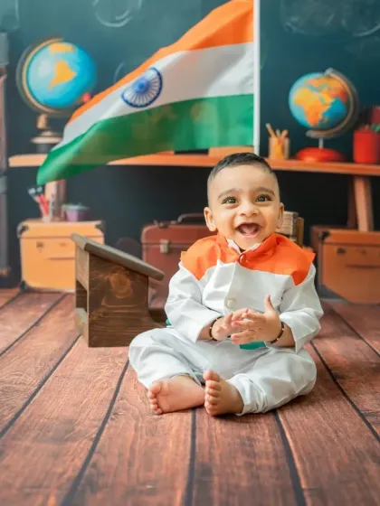A joyful moment captured during the Republic Day shoot. The baby's happy expression and tricolor outfit perfectly convey a sense of celebration and national pride.
