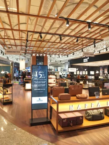 A shot of the leather goods and accessories section, featuring brands like Boss and Montblanc. We focus on capturing the textures and quality of high-value products within their retail setting.