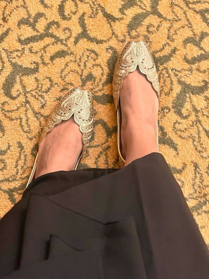A closer look at a pair of hand-embroidered juttis from the Nazrana collection. The delicate threadwork and scalloped edge create an elegant and timeless design that pairs beautifully with both traditional and contemporary outfits.