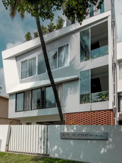 A residence where light, shadow, and geometry come together in perfect harmony. Crisp white planes carve out dynamic forms, while the perforated brick screen at the base adds warmth and texture.