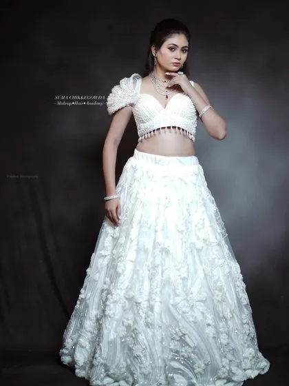 An angelic look in a white lehenga, perfect for a reception. I created a soft, glowing makeup look with a subtle pink eyeshadow and a matching lip to give the bride a dreamy, ethereal feel.