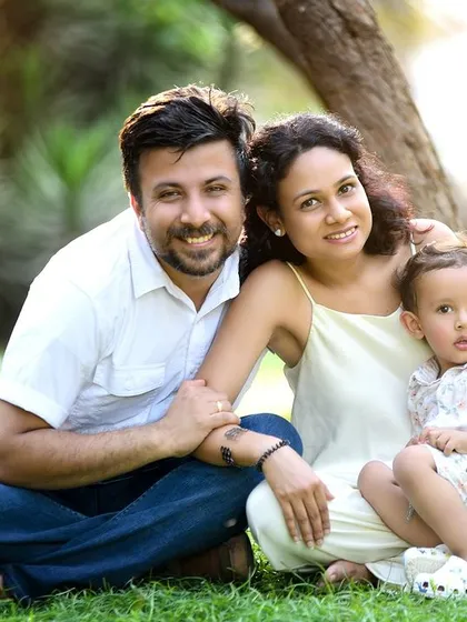 A lovely family portrait taken on the grass during an outdoor session. The family's comfortable and connected pose, combined with the beautiful natural setting, makes for a perfect keepsake.