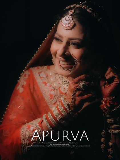 A close-up portrait of a bride smiling, captured in a warm, low-light setting.