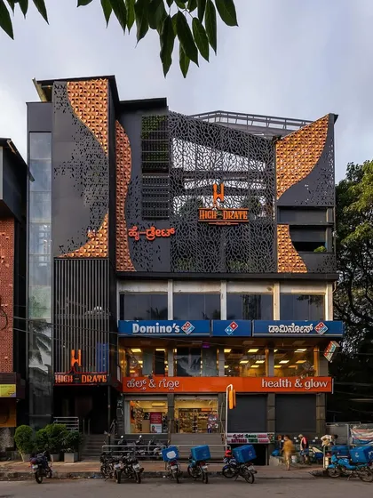 We thrive on adaptive reuse projects, reimagining dated buildings into modern landmarks. This facade metamorphosis for the 'High-drate' restopub uses a combination of perforated metal, brick cladding, and vertical gardens to create a dramatic and contemporary new identity.