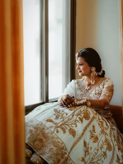 A serene shot of the bride, her hair styled in a beautiful braid, ready for the Haldi rituals.