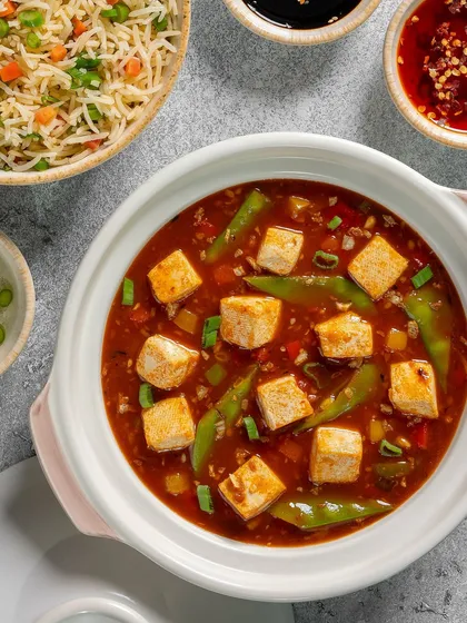 A close-up of the Mapo Tofu, showing the soft tofu cubes in a spicy sauce.