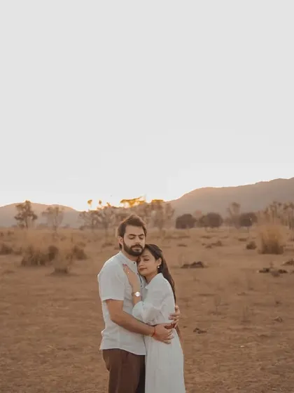 A tender embrace at sunset. The soft, warm light of the golden hour creates a romantic and intimate mood, perfect for capturing the quiet connection between a couple.