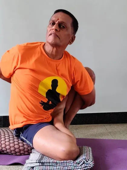 Marichyasana 2. This is a more complex variation involving a half-lotus bind, which deeply opens the hip and shoulder while incorporating a forward bend.
