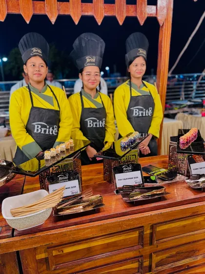The team at the Japanese food station, offering a selection of sushi including Chicken Uramaki, Fish Californian Roll, and Prawns Tempura.