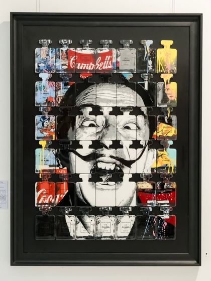 "Dali In A Bottle" distills Salvador Dalí’s surreal madness into iconic containers of pop culture. His face emerges through sculpted bottles of Chanel, Coca-Cola, and Campbell's, trapping genius in the language of consumerism.