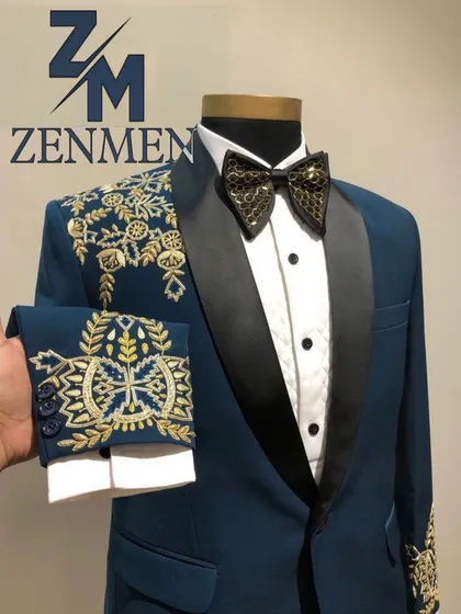 Showcasing the detailed embroidery on the cuff of the teal tuxedo, which matches the shoulder design. The custom-designed bow tie completes this bespoke look.
