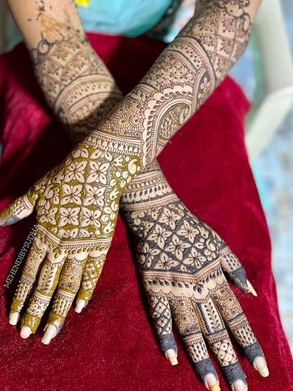 A unique bridal design focusing on intricate grid and floral patterns, creating a beautiful 'jaal' effect across the hands.
