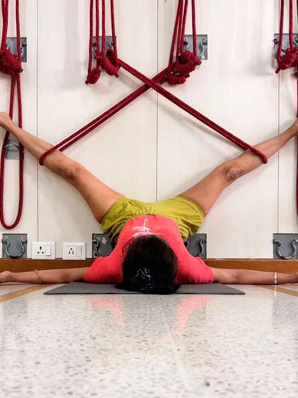Supta Konasana is practiced here with the legs supported by wall ropes. This allows the inner thighs and groin to open passively, without strain. The support of the ropes helps the body to release and the breath to become smooth and rhythmic, a key principle in pranayama.