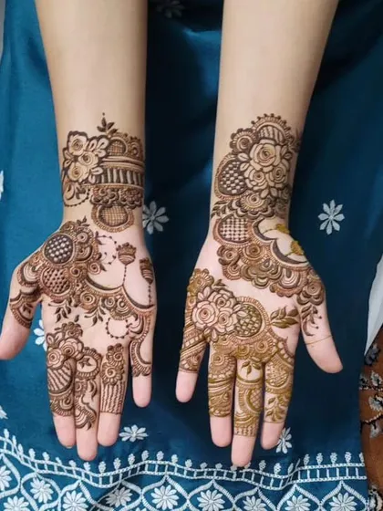 This is a beautiful example of an Indo-Arabic party mehndi design. It combines bold floral elements with intricate patterns and uses negative space to make the artwork pop. I even added a little jhumka design for a trendy touch.