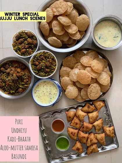 A winter special Gujarati lunch with Puri, Undhiyu, Kadhi-Bhaath, and Samosas.