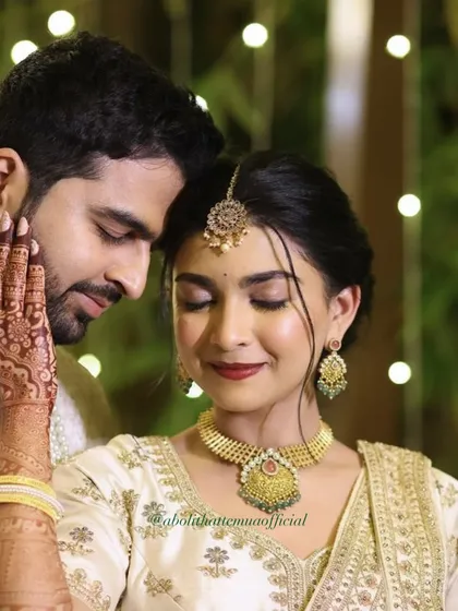 For this couple's ring exchange ceremony, I created a timeless and romantic look. The focus was on luminous skin, a classic red lip, and beautifully defined eyes that complemented her intricate henna and stunning white and gold lehenga.