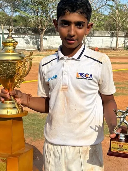 Darshan Rathod, the Man of the Match in the MSV Cup final, with the championship trophy.
