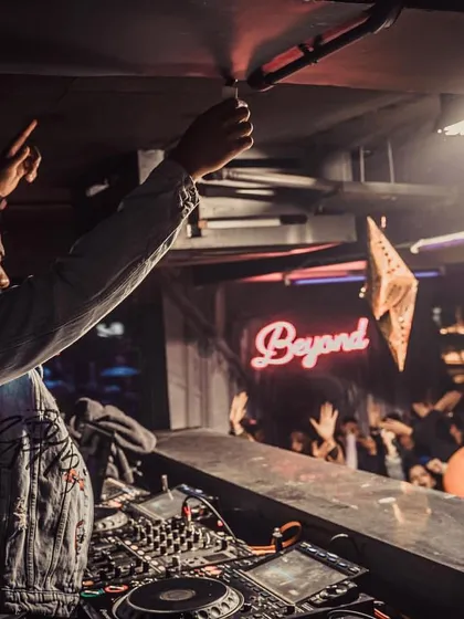 In the zone, with the crowd right there with me. This is the core of what I do: reading the room and dropping the perfect track to keep the energy soaring all night long. A packed club night is my playground.