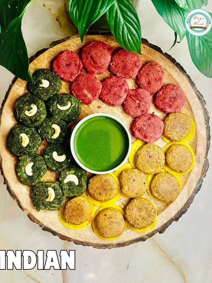 A vibrant platter of our Indian appetizers. This dish showcases our colorful variety of vegetarian kebabs, including beetroot and hara bhara, served with a fresh green chutney.