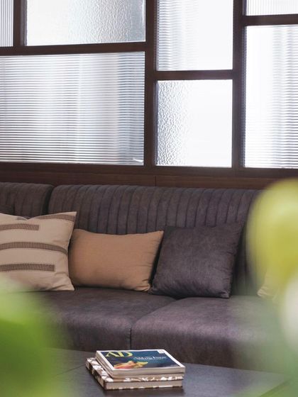Another view of the fluted glass partition, this time with a soft focus on a plant in the foreground, highlighting the layers and depth in our interior compositions.