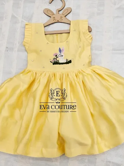 A sweet yellow frock with delicate rabbit embroidery on the bodice. A perfect, comfortable choice for a party.