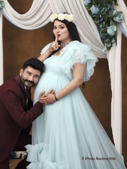 A playful and loving moment between the expecting parents. The dad-to-be leans in to listen to the belly, while the mom-to-be shares a little secret, making for a fun and memorable shot.