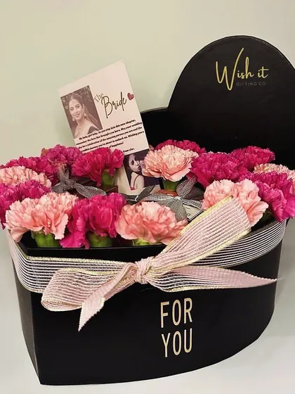 A heart-shaped box filled with carnations and personalized notes for a special bride-to-be. It’s a beautiful way to celebrate her journey to forever.