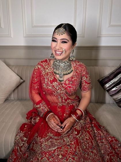 The joy on her face says it all. This bride chose a heavy polki set to complement her beautiful red lehenga.