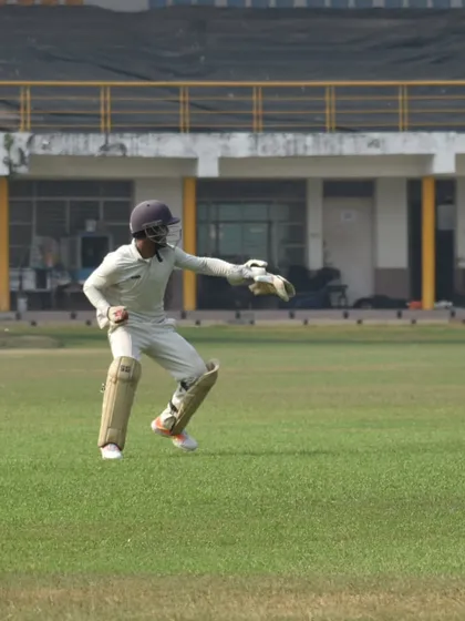 Focus and agility behind the stumps. Our wicketkeeper in action, showcasing the high level of alertness and skill we cultivate in our players during training and matches.