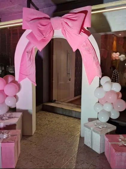 Another take on the bow trend. This time, a giant pink bow sits atop an archway, creating a picture-perfect entrance for a party.