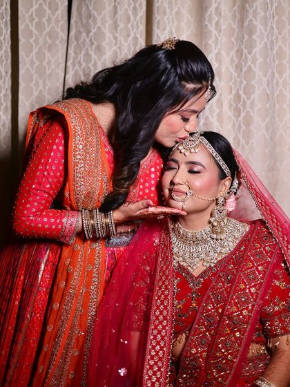 A tender moment between sisters. The bride's makeup is complemented by the soft glam look I created for her sister.