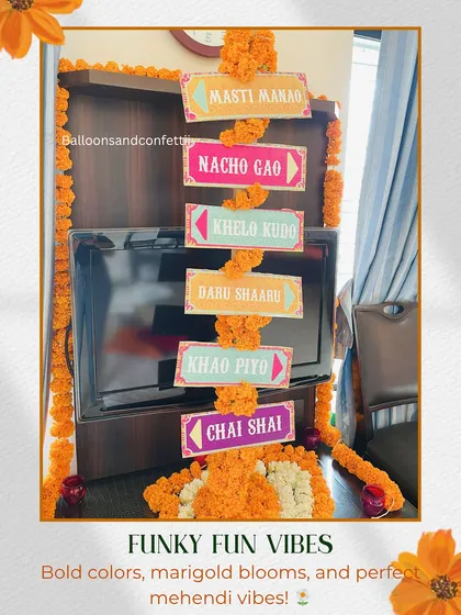 Funky and fun signs are a great way to add personality to a Mehendi event. These colorful signs with playful Hinglish phrases like 'Nacho Gao' and 'Khao Piyo' are framed with marigold garlands to guide the party vibe.