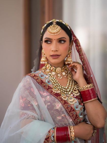 I loved my bride's unique outfit choice. The combination of blue and maroon is so regal. I created maroon halo eyes and an ombre lip to complement the look.