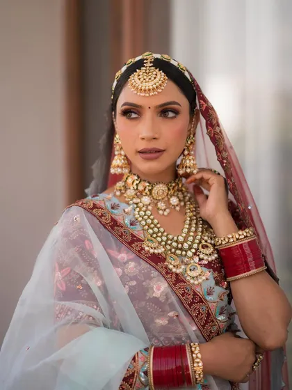 I loved my bride's unique outfit choice. The combination of blue and maroon is so regal. I created maroon halo eyes and an ombre lip to complement the look.