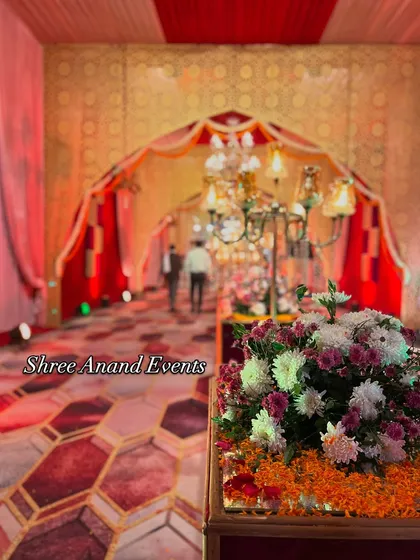 A guest's perspective of the grand entrance, with a floral centerpiece in the foreground and the beautifully lit, arched walkway stretching into the distance.