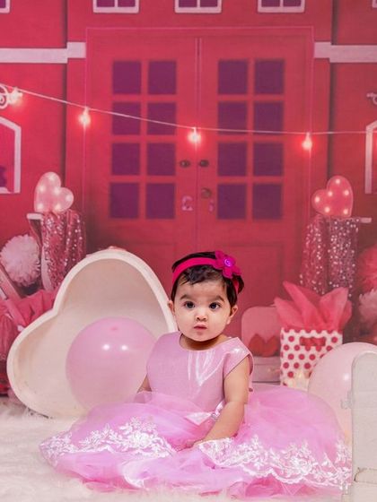 A different angle of the Barbie-themed shoot, showing the intricate details of the pink house backdrop and accessories.