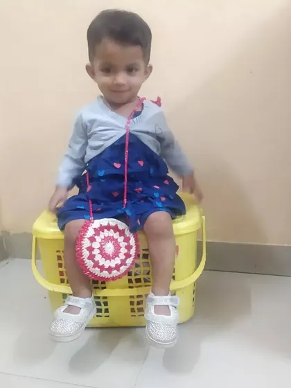 A final, precious photo of my daughter modeling the crochet bag I made for her.