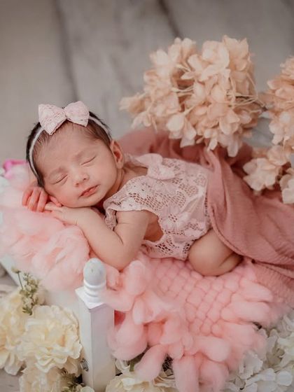 A princess on her floral bed. This setup uses a miniature bed and is adorned with soft pink flowers for a delicate and romantic feel.