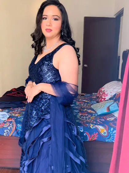 Another angle of the navy blue gown look. The soft curls and flawless makeup create a timeless and classic style.