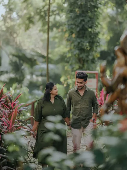 A walk through a lush garden, hand in hand. This candid shot from their resort pre-wedding session captures a simple, happy moment.
