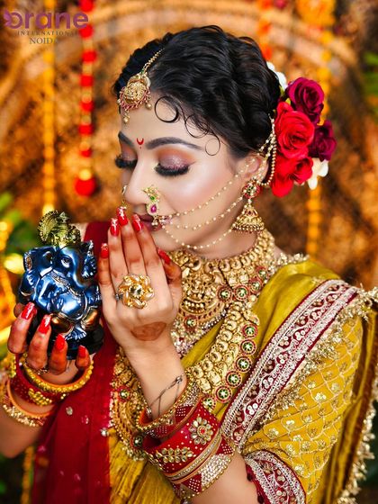 A devotional pose from our Ganesh Chaturthi-themed shoot, highlighting the warm, glowing makeup and traditional Maharashtrian jewelry.