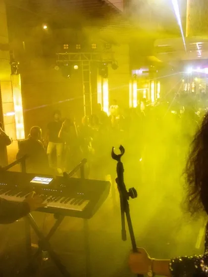 A shot from the stage looking out into a hazy, excited crowd. The stage lights and smoke effects are part of the full concert production we bring to every event to create an immersive experience.