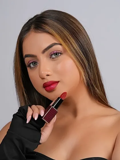 A clean, studio-lit beauty shot for a lipstick campaign. The focus is entirely on the product and the model's flawless application, demonstrating my skill in creating commercial-grade cosmetic photography.