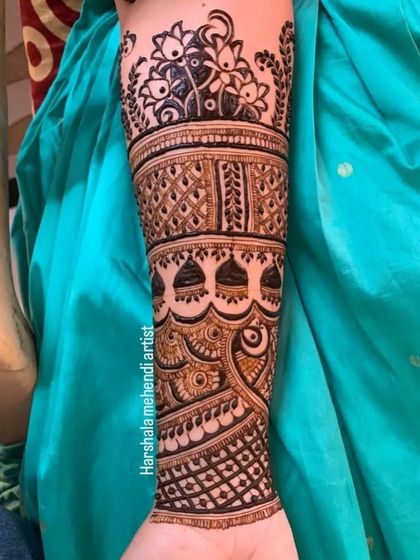 A close up of a single arm from a bridal set. This showcases the level of detail in my work, with fine lines, shaded leaves, and a peacock motif.