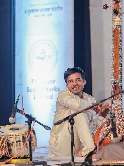 A gallery of cherished moments accompanying the legendary vocalist, Guruji Padma Bhushan Pandit Ajoy Chakraborty ji, at various prestigious festivals.