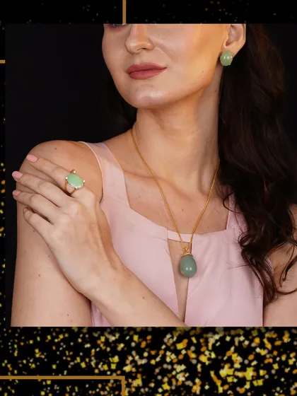 A model displays a beautiful jade pendant necklace and matching earrings, a set that speaks of serene elegance.